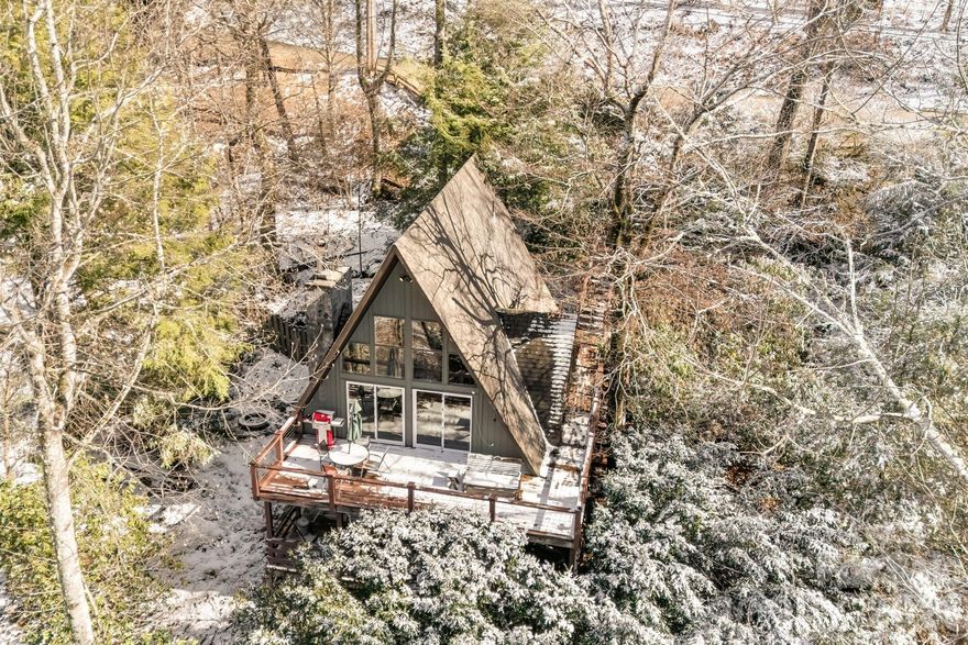Tucked away in the sought-after Wolf Laurel gated community, this charming A-frame cabin offers the perfect blend of cozy mountain living and investment potential. Surrounded by the beauty of Western North Carolina, this fully furnished retreat is completely turn-key and currently operating as a successful short-term rental, making it an ideal opportunity for those seeking a year-round getaway or income-producing mountain escape.

Inside, the classic A-frame design creates a warm and inviting atmosphere with comfortable living spaces designed for relaxing after a day in the mountains. Step outside and enjoy the breathtaking mountain views and everything this vibrant community has to offer, including access to the Wolf Laurel Country Club golf course, nearby ski slopes at Hatley Pointe Ski Resort, pickleball courts, scenic walking trails, playgrounds, and a refreshing outdoor pool. 

Whether you're looking for a peaceful mountain retreat, a vacation home to share with family and friends, or a ready-to-go short-term rental, this cozy A-frame offers the best of mountain living in one of the area’s most desirable gated communities.