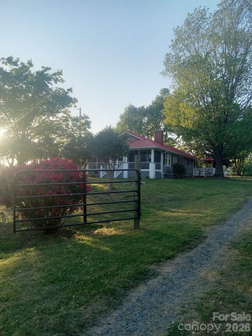 A very rare, beautiful, 3.21 acre farm in the Locust community.  The mid-century home was  completely renovated and updated in 2018 with new electrical, plumbing, HVAC, whole house generator and much more, please see the attached detailed list of modernizations. As a result it is now a modern, literally like new, 3 bedroom home with 2 full baths.  The primary bedroom/bath suite is large with a doorless tile and glass shower. Add to this a screened-in front porch, a deck and plenty of land and farm buildings already in place. For leisure a Swimming/Spa with a raised deck and sundeck is just steps from the main house.  Many appliances are included with this home making it literally move in ready with few additions needed. The grounds include a fenced, pastured front, back and side area, a vintage 46ft. X 36ft. tin sided six-stall barn with a hay loft, in great condition.
Once an egg producing farm, a block/concrete floor egg house remains very solid.  An early 1900's or late 1800's wooden shop also remains from former farm days.