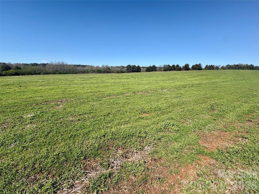 Over 61 acres of newly surveyed prime farmland and hunting land with a flowing creek that borders the property.  This gorgeous land also offers potential as a large tract subdivision (10+ AC) in the sought-after northern Iredell County area! Ideal for hunting, crops, hay, a private estate, or an outdoor getaway. Just minutes from I-40, I-77, and only 7–10 minutes from downtown Statesville! The property, accessed via a dedicated easement, could be subdivided into 10+ acre lots, perfect for families wanting to split the land or builders seeking lots with room to grow. Zoned R20—stick-built homes only, no manufactured housing. Bring your ATVs and enjoy this scenic property, perfect for farming, hunting, private residences, and more. Current crops must be harvested by the farmer, and tree stands removed. Centrally located between Winston & Hickory, Boone & Charlotte! The location is PRIMO! Checking the status of availability of county water access. Additional acreage available to give road frontage to Midway which makes the possibilities endless along with potential for subdividing. Portion of a larger track being sold.