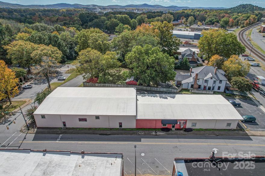 This versatile commercial building is located in the heart of downtown Kings Mountain on a prominent corner lot with strong visibility and access. The property is located within a designated Opportunity Zone, offering potential long-term tax advantages for qualified buyers. Currently operating as a successful dance and gymnastics studio, the property offers flexibility well beyond its current use. Positioned at two signalized intersections, the site benefits from consistent vehicle and pedestrian traffic within a well-established downtown environment.

The property is conveniently located just minutes from Two Kings Casino and provides easy access to Interstate 85 and U.S. Highway 74, supporting strong regional connectivity. This location is well-suited for a wide range of commercial, professional, and service-oriented uses.

The building contains approximately 10,977 square feet, with roughly 5,500 square feet dedicated to open studio space featuring high ceilings suitable for a variety of uses. Additional areas include a small church space, office areas, and storage. The property is equipped with three bathrooms and a kitchen, providing functional infrastructure for continued commercial use or future repositioning.

The layout, location, and zoning make this property well-suited for owner-users, investors, or redevelopment opportunities.