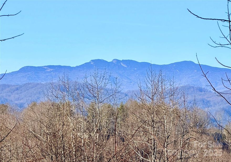 2-acre home site on breathtaking Soaring Top Lane, the highest peak at The Coves Mountain River Club, with panoramic long range mountain views including Grandfather Mountain and the South Mountains. Lot 971 is toward the top of the culdesac. Perc-ed for 3 bedrooms.  Septic permit has expired. Electric and fiber optic cable buried at front of lot.
Capture the views on all sides of your home, Grandfather Mountain and the sunset views from the great room and  back porch and deck and the South Mountain views from the front porch. Lender and builder info available. The Coves is a 3200-acre gated outdoor lifestyle community on 5 miles of the Johns River. Private trails to hike, bike, ride horses or UTVs. Fabulous 6,000 sq ft post & beam clubhouse with vaulted ceilings and a 3-sided fireplace.  Outdoor fire rings. Porches and decks on two levels are ideal for alfresco dining, spectacular sunsets, stargazing, and taking in 360° views of the Blue Ridge Mountains, South Mountains, and Brushy Mountains. Fitness center, locker rooms.  The Coves has 2 equestrian centers, pickle-ball, putting green, dog park, riverfront parks with picnicking and horse shoes,  vineyard, community garden. Kayak, tube, or fish Johns River, on site. 30+ clubs to join. 500,000 acre Pisgah National Forest and Wilson Creek Wild and Scenic River Area are just outside the gates.  1.5 hour to Charlotte or Asheville. Minutes to Blowing Rock, Lenoir, Morganton, and the Blue Ridge Parkway.