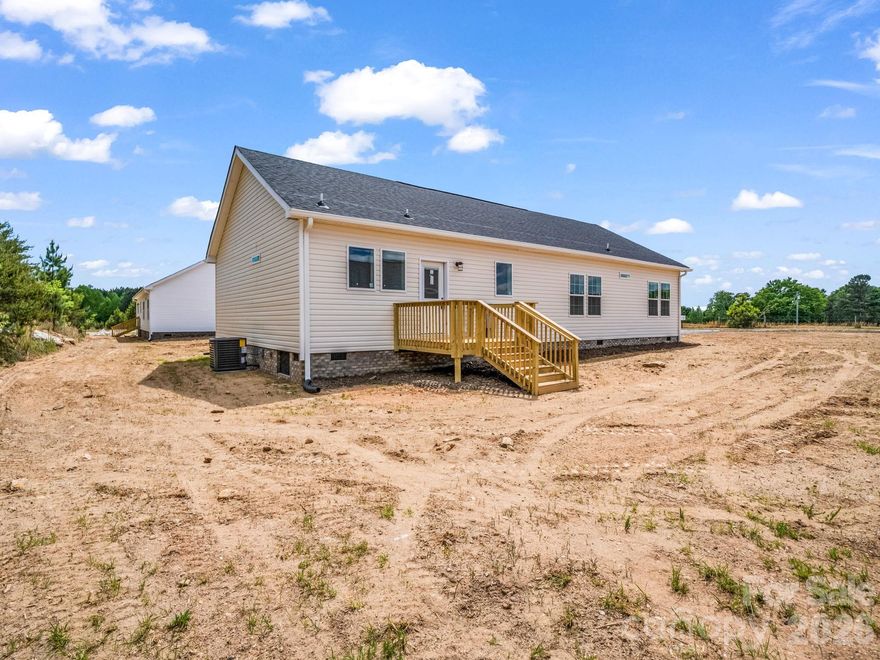 Stunning new construction - this beautifully finished 3-bedroom, 2-bath home offers modern design, quality craftsmanship, and effortless one-level living. Comfort and functionality are key features in this off-frame modular home. Inside you'll find 9 ft ceilings, 8 foot doors, crown molding, expansive windows and an open, light-filled layout.  The kitchen is a true centerpiece featuring quartz countertops, a large center island with seating and an undermount stainless steel sink, vented range hood, ample cabinetry, designer tile backsplash, matte black fixtures and all new appliances.  The spacious living area flows seamlessly into the kitchen and dining space, perfect for both everyday living and entertaining.  The primary suite offers a relaxing retreat with freestanding soaking tub, dual vanities, and a beautifully tiled walk-in shower with glass enclosure. The 2 additional bedrooms provide flexibility for family, guests or a home office. Additional highlights include low-maintenance vinyl flooring in the living areas and cozy carpet in the bedrooms, a dedicated laundry room and stylish lighting. Enjoy all the benefits of new construction-modern finishes, efficiency, and low maintenance, ready for you to move right in!   Situated along HWY 221 in Forest City, this home offers quick and easy access to major highways, making commuting a breeze and providing convenient access to both North and South Carolina.