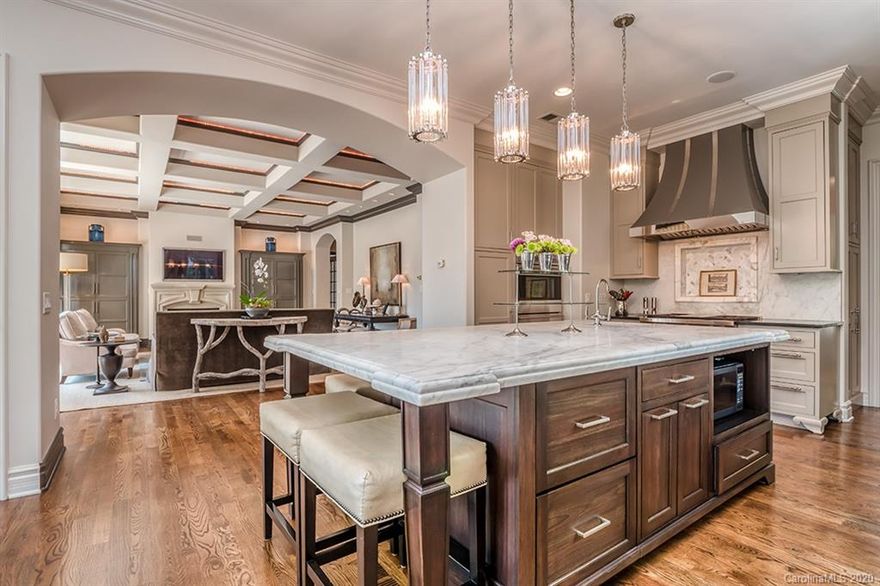 French country manor house -  just minutes from uptown Charlotte. Located on lovely winding Meadowood Lane this stately home offers elegance and privacy on its almost two-acre lot.  Four levels of comfortable living with the WOW! Factor. Graciously proportioned rooms on every level. The gourmet kitchen was custom designed and has every feature you deserve: Wolf Cooktop, built-in sub-zero refrigerator with custom cabinetry, Meile Coffee Maker, and more.  Master on the main with gorgeous renovated marble bath with his and her closets. Upstairs, each of the four bedrooms has a private bath, plus there is a large family room hang out.  The attic level is reminiscent of a Paris Pier-de-Terre with cozy rooflines, a fireplace, and a private bath. Downstairs features a huge rec room, theatre room, exercise, or guest room with a private bath plus a wine cellar.  All this opens out to the stunning pool and private yard with sports court. Elevator and 4 Car Heated and Cooled Garage too.