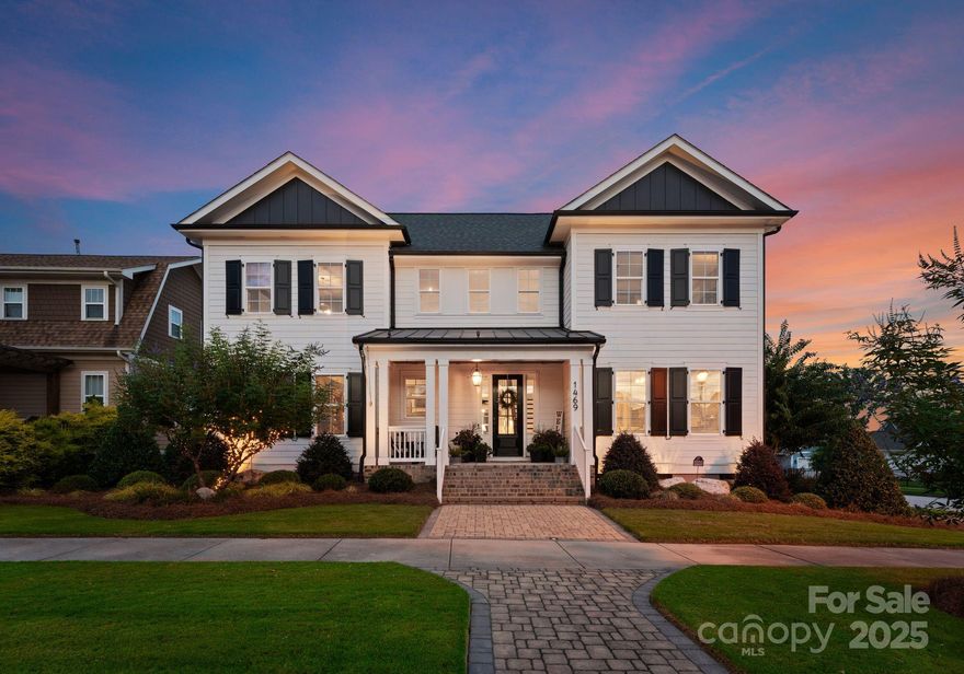 Built in 2018, this stunning estate home pairs timeless detail with thoughtful updates and inviting outdoor living. Step inside to find 9’ ceilings on both levels, enhanced by elegant crown molding, custom trimwork, and designer lighting throughout. A soaring two-story foyer welcomes you into the main level, where a private office with French doors, a formal dining room with tray ceiling, and a separate lounge create flexible living spaces. The open-concept kitchen and living room form the heart of the home, featuring a gas fireplace, large island centerpiece, quartz countertops, custom backsplash, and upper and lower cabinetry. The main-level primary suite impresses with its size and thoughtful design, offering tray ceilings and backyard views from the bedroom and a generous ensuite bath featuring dual vanities, a tiled walk-in shower, a private water closet, and a custom walk-in closet. Upstairs, three additional bedrooms provide excellent space: one with its own ensuite, and two connected by a Jack & Jill bath with private, separate vanity and shower areas. Outdoor living shines with a fully fenced yard, lush landscaping, covered deck, stone patio with fire pit, and oversized three-car garage with storage space. Located in Rock Hill’s beloved Riverwalk community, this home offers a cozy, sidewalk-lined neighborhood with a playground and close proximity to the Rock Hill Outdoor Center Greens park, Riverwalk retail district, the Catawba River, and the BMX Supercross Track.