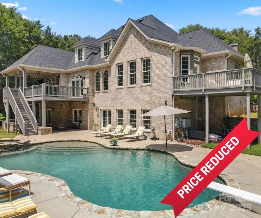 **Price reduction can be used for buying down rate or if desired, leave the funds in escrow towards updates post closing**  This stunning 6-bedroom, 5.5-bathroom home in Huntersville is situated on 8 acres of lush land, featuring a gated entrance that opens to a picturesque driveway. The primary suite, located on the main floor, boasts a private bath and balcony. The chef's kitchen is equipped with top-of-the-line appliances, making it a culinary dream. Additionally, the main floor includes a second bedroom, while three more bedrooms and two bathrooms are located upstairs. The basement offers a fully equipped living space with a kitchen and walk-in pantry, leading to a backyard oasis with a resort-style pool, hot tub, and two outdoor bathrooms. An outdoor living room with a wood-burning fireplace enhances the charm. A kids' dream treehouse is situated near the pool. The property also features a second living quarters above the detached garage, complete with 1 bedroom and 1 bath.