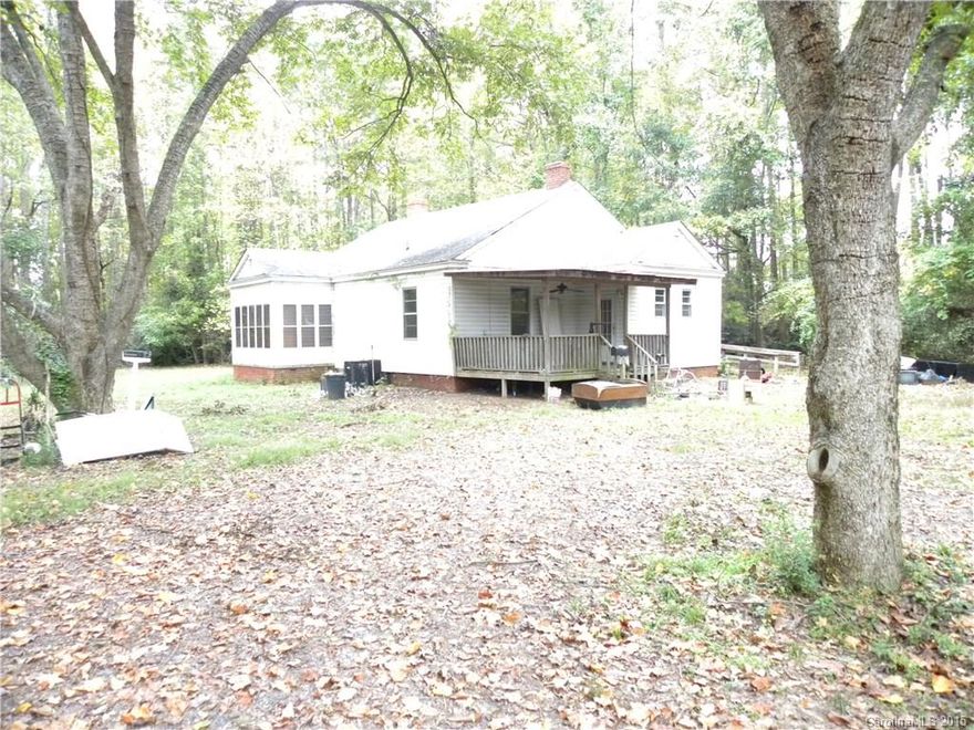 Charming bungalow features large bedrooms. Rocking chair front porch and a great deck overlooking spacious, 1 acre, private back yard. This home has lots of potential! Playgrounds, parks and walking trails close by. Greenway just a few minutes away! Nice lot with potential for great outdoor entertaining space. Minutes from I-77. Award winning Fort Mill schools! Home being sold "as is". Great opportunity for investment or "flipper".