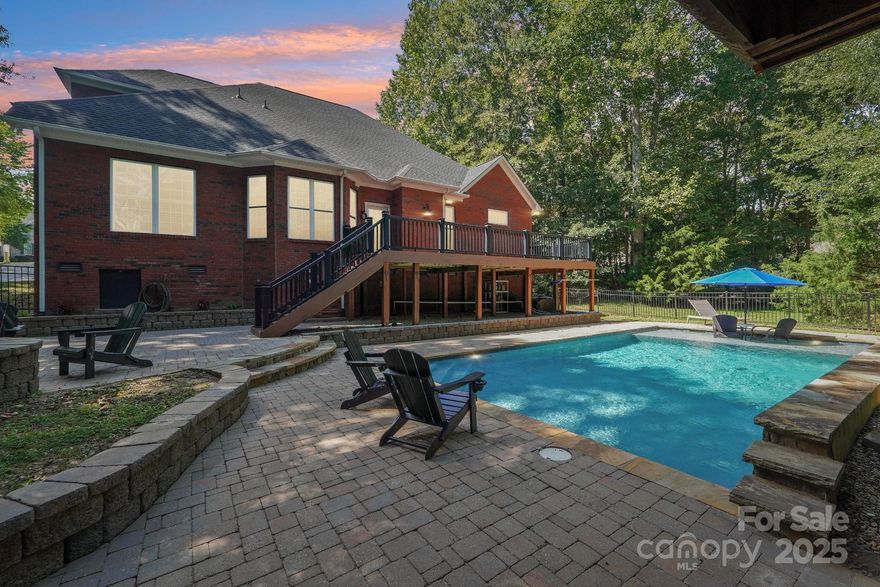 Discover peaceful, private living near Lake Wylie in this beautifully designed 4-bedroom, 3-bath custom brick home on 0.52 acres (with an optional adjoining lot available for a total of 1.09 acres). This property blends relaxed everyday comfort with incredible outdoor living—perfect for buyers searching for space, privacy, and a move-in-ready home close to the lake.
Step into a vaulted foyer that leads to an open, inviting floor plan. The vaulted great room features an oversized gas fireplace and flows seamlessly into the kitchen and breakfast area, creating an ideal layout for entertaining. The kitchen includes granite countertops, gas cooktop, wall oven with microwave, two pantries, and plenty of cabinetry—everything today’s buyers look for in a modern, functional kitchen.
The primary bedroom on the main level offers true retreat-style living with heated tile floors, dual vanities, double walk-in closets with built-in organizers, and a spa-inspired shower with dual shower heads. A remodeled main-floor guest suite provides privacy for visitors, along with a spacious laundry room with a sink.
Upstairs offers even more flexibility with two additional bedrooms, a large full bath, and a bonus room with closet—perfect as a media room, home office, or play space.
Step outside to your own private backyard oasis featuring a sparkling in-ground pool, outdoor kitchen, gas firepit, and a huge composite deck overlooking the natural landscape. Ideal for summer gatherings, quiet evenings, and year-round enjoyment. Home includes all appliances and pool equipment, plus a dedicated irrigation well to reduce watering costs.
Additional highlights include an oversized garage with two Tesla EV chargers, custom storage, and plenty of driveway space. This home checks every box for buyers searching for a Lake Wylie pool home, a brick home with acreage, or a property offering both privacy and convenience.
Listing agents are owners.