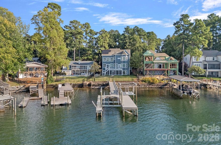 Enjoy some of the most dramatic long-range lake and sunset views Lake Norman has to offer from this exceptional waterfront home. Nestled in the highly desirable Island Forest community, this property delivers an unparalleled blend of luxury, comfort, and breathtaking natural beauty. Step inside the dramatic two-story great room, where expansive windows capture sweeping lake vistas and fill the home with natural light. The beautifully updated gourmet kitchen features high-end appliances, generous workspaces, a large island, and elegant finishes—perfect for both everyday cooking and entertaining. The fully finished lower level provides an additional living and entertaining hub, complete with a full bar, a dedicated wine room, and flexible spaces ideal for gatherings, recreation, or hosting overnight guests. Outdoors, your private lakeside retreat awaits. A fenced yard, direct access to the water, a boat lift, and a jet ski lift make lake living effortless. Spend evenings by the water’s edge, take off for sunset cruises, or simply relax and enjoy the panoramic views from your backyard.
Additional features include gleaming hardwood floors throughout the main level and 39 solar panels, offering impressive energy efficiency and long-term savings. This remarkable property is the perfect blend of luxury living, thoughtful design, and the captivating beauty of Lake Norman—an opportunity not to be missed.