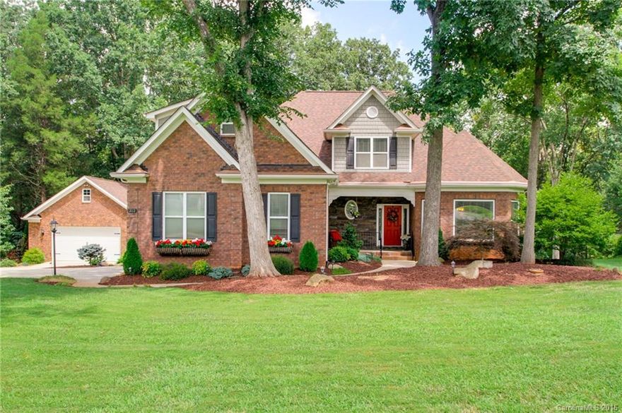 BELOW RECENT APPRAISAL! Immaculate full brick home on almost an acre. Loaded with upgrades including hardwood floors, stacked stone fireplace, and a dream kitchen with stainless appliances, wine chiller, gas range, pot filler, farmhouse sink, custom cabinets, and granite countertops. First-floor master and laundry. Screened porch and deck overlook wooded, fenced backyard. 2-car garage plus 832 sq. ft. detached garage. Minutes to downtown Davidson w/ low Rowan county taxes. 1 yr. home warranty.