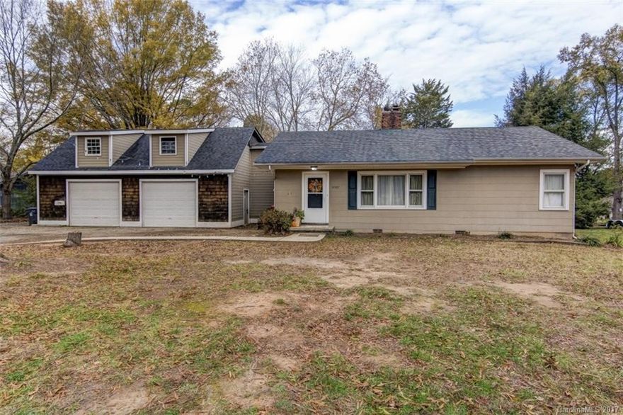 Quaint 3BR home  on large lot with winter views of the lake. Oversized two car garage with 2nd floor storage area plus two storage sheds and covered carport. Excellent investment property. Living room, dining room and mud room with hardwoods throughout. Kitchen features white cabinets, built-in microwave.. Garage exterior is cedar shake & concrete board. House exterior siding is unknown. Tax record shows asbestos however similar homes in area are concrete board.