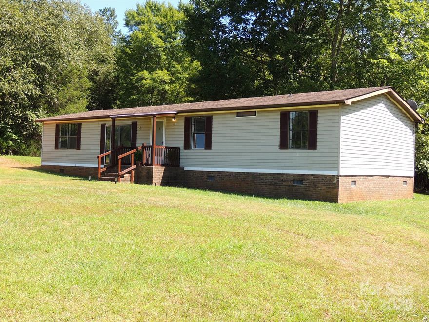 "PRICE IMPROVEMENT" 3 Bedroom, 2 Full Bath 1440 SF DWMH located on a private street near US HWY 221 in the Gilkey/Union Mills area convenient to Rutherfordton and Marion. 3 miles to the Rails to Trails Trail at Gilkey. This home has a large level yard, spacious living room, dining room and additional den opening to large deck overlooking private, shaded backyard.  This home also has an office with a closet. Septic Permit is for a 3 Bedroom. The open floor plan has separated owner suite from additional bedrooms.  OWNER IS OFFERING $5000.00 Buyer Assistance for Closing Cost, Rate Buy Down or as Buyer wishes to use. This home is being SOLD AS IS. This home needs minor updates but is very livable.