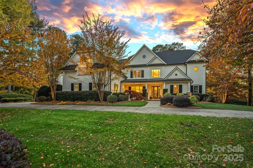 This stunning golf course estate offers the ultimate luxury lifestyle, delivering both a Deeded Boat Slip and Trump National Golf Club access right to your doorstep perfectly complementing the stunning golf course views overlooking the TNGC 11th Hole that define this premier property.

Set on a double, well-manicured 1.55-acre lot, this home boasts exquisite features inside and out. Enjoy year-round entertaining with a newly built heated saltwater pool and spa and an extensive travertine patio. The home itself is designed for grand living, featuring an incredible 4-car garage configuration (attached 2-car plus a detached two-level garage with workshop), and a stately circular driveway leading to an inviting flagstone porch.

Inside, discover a beautifully updated space with wide plank walnut hardwood floors throughout the main level, soaring 10-foot ceilings and 8-foot doors, and high-end finishes like stacked crown molding. A dedicated Wet Bar, a Two-Story Great Room with a massive stacked stone fireplace, and an executive Office are just a few of the highlights. The Gourmet Kitchen was recently refreshed showcases a magnificent book-matched granite island, commercial-grade gas cooktop, and premium appliances.

Retreat to the luxurious Owner's Suite, featuring a large balcony access and a brand-new, $100,000+ primary bathroom. This spa-like retreat boasts real wood his-and-her vanities with stylish counters, custom back-lit picture-framed mirrors, a freestanding soaking tub, and a country club-sized steam shower with elegant glass arched doors, a rain head system, and dual shower heads, all surrounded by gorgeous tile and a wrap-around floating bench. The suite is completed by separate his & hers custom walk-in closets.

The Upper Level is equally impressive, boasting three generously sized bedrooms, a spacious Bonus Room, and a second office/Flex Room.

The Lower Level is an entertainer's dream, complete with a Billiard/Recreation Room, Family Room with a stone fireplace, and a Fifth Bedroom/Bonus Room. The lower level features multi generational private Second Living Quarters with a full kitchen, bedroom, bath, and separate entrance.