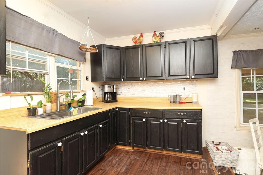 Rare Opportunity:  In the "4's% Assumable Rate" Available! Cut your monthly housing payment dramatically with an incredible, assumable mortgage option in the mid-4% range on this solid, all-brick ranch! Nestled on a spacious, private half-acre lot close to downtown Lancaster, this home offers massive financial value alongside endless potential. Step inside to find a bright living room with a fireplace, a large eat-in kitchen with abundant cabinetry, and a flexible dining space. The primary bedroom features a unique connected bonus room—perfect for an oversized walk-in closet, home office, or nursery. Outside, enjoy a peaceful, tree-lined backyard ideal for pets and gardening, complete with a detached 2-car carport and an extended turnaround driveway. Don't miss out on a rare chance to lock in yesteryear's interest rates today!Welcome to this charming all brick ranch home in Lancaster, SC, featuring 2 bedrooms and 1.5 bathrooms, Freshly Painted on a spacious half-acre lot. Step inside to enjoy a bright front living room with fireplace, a large eat-in kitchen with plenty of cabinets and counter space, and a flexible dining or sitting room just off the kitchen. The primary bedroom includes a bonus room that can be used as an office, nursery, or oversized closet to fit your lifestyle.

This home  Lancaster home also offers a full hall bath and a convenient half bath off the kitchen. Outside, relax in the private backyard surrounded by mature trees—perfect for outdoor entertaining, gardening, or pets. A covered 2-car carport and extended driveway with a turn-around provide easy parking and storage.

Located close to downtown Lancaster, schools, parks, and shopping, this home is ideal for buyers looking for comfort, convenience, and plenty of outdoor space in a quiet setting.  this home has an assumable mortgage through movement per the seller.