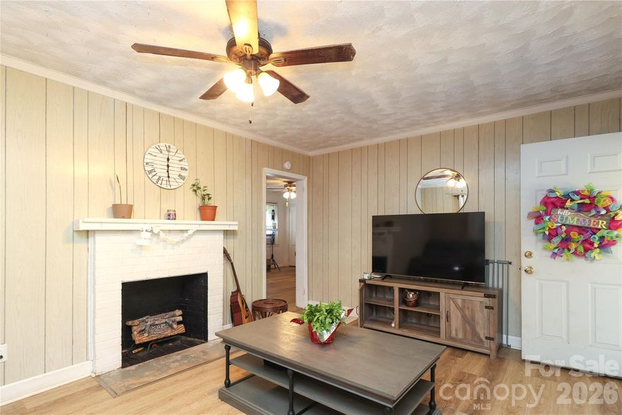Rare Opportunity:  In the "4's% Assumable Rate" Available! Cut your monthly housing payment dramatically with an incredible, assumable mortgage option in the mid-4% range on this solid, all-brick ranch! Nestled on a spacious, private half-acre lot close to downtown Lancaster, this home offers massive financial value alongside endless potential. Step inside to find a bright living room with a fireplace, a large eat-in kitchen with abundant cabinetry, and a flexible dining space. The primary bedroom features a unique connected bonus room—perfect for an oversized walk-in closet, home office, or nursery. Outside, enjoy a peaceful, tree-lined backyard ideal for pets and gardening, complete with a detached 2-car carport and an extended turnaround driveway. Don't miss out on a rare chance to lock in yesteryear's interest rates today!Welcome to this charming all brick ranch home in Lancaster, SC, featuring 2 bedrooms and 1.5 bathrooms, Freshly Painted on a spacious half-acre lot. Step inside to enjoy a bright front living room with fireplace, a large eat-in kitchen with plenty of cabinets and counter space, and a flexible dining or sitting room just off the kitchen. The primary bedroom includes a bonus room that can be used as an office, nursery, or oversized closet to fit your lifestyle.

This home  Lancaster home also offers a full hall bath and a convenient half bath off the kitchen. Outside, relax in the private backyard surrounded by mature trees—perfect for outdoor entertaining, gardening, or pets. A covered 2-car carport and extended driveway with a turn-around provide easy parking and storage.

Located close to downtown Lancaster, schools, parks, and shopping, this home is ideal for buyers looking for comfort, convenience, and plenty of outdoor space in a quiet setting.  this home has an assumable mortgage through movement per the seller.