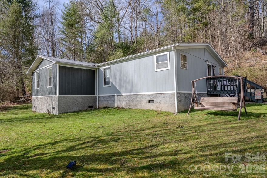 Move-in ready and nicely updated with motivated sellers! This well-maintained double wide sits on approximately 0.8 acres along Hanging Rock Rd and features numerous updates throughout, creating bright and comfortable living spaces. The home offers a functional layout with a welcoming feel, along with a bonus room that adds flexibility for an office, guest space, or additional living area. Outside, enjoy a pleasant front yard great for relaxing and taking in the mountain setting, along with an enclosed backyard for pets or outdoor enjoyment. Conveniently located just a short drive to Spruce Pine and Burnsville for shopping, dining, and everyday amenities. A great opportunity for a full-time residence, mountain getaway, or investment property.