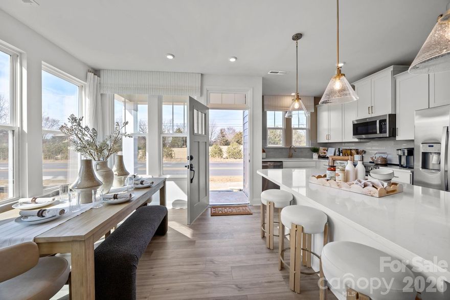 Welcome to Odell Park Premier Townhomes Offering the Most Convenient Access to Regional Commuter Routes and Concord Mills. Our Rochester plan features 3BR / 2.5BA  with a 1-car garage offering modern design and practical spaces just minutes to I-485 , Highland Creek, and Concord Mills Blvd. The main level features an open-concept layout with luxury vinyl plank flooring. The kitchen includes quartz countertops, stainless steel appliances, a spacious island, and an approximately 12' deep finished storage closet—ideal for pantry or utility use. A bright dining area and connected family room make the space inviting for both daily living and entertaining. Upstairs, the Rochester plan offers three bedrooms, two full baths, and a convenient laundry closet. The primary bedroom and bathroom highlight a 5' tiled shower, dual vanities, and a large walk-in closet. Secondary bedrooms provide flexibility for work-from-home, guests, or hobbies. Odell Park offers quick access to  shopping, dining, parks, major highways, UNC Charlotte, and local employment centers. HOA services cover water, trash removal, lawn care, and landscaping, supporting a low-maintenance lifestyle in a convenient Charlotte location. This home is under construction and scheduled to be completed by the end of March/ Beginning of April 2026 giving buyers the opportunity to plan ahead and secure new construction at today’s pricing.