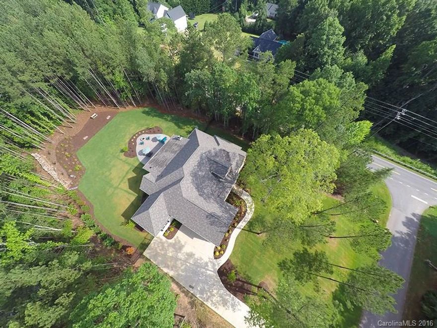 Stunning custom ranch on two private acres filled with upgrades in Fort Mill schools.Features include hand scraped hardwoods throughout,large office, lots windows allowing tons of natural light,coffered ceilings,stone front fireplace and accordion doors that lead to a large and impressive outdoor living space. Large bonus/bedroom upstairs (has water lines run allowing for the addition of a bathroom). The gourmet kitchen suits any home chefs needs. The list goes on,this home is truly a must see.