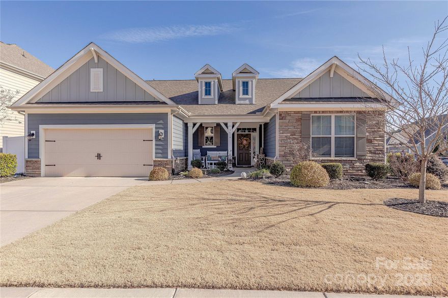 Situated on a premium corner lot in Indian Land's desirable community of Carrington, this updated ranch style home with flexible second story comes with its own backyard oasis. Hardwood floors unite a natural light filled open concept floor plan. Grand 2-story great room is finished with 15' ceilings and fireplace. Gourmet Chef's kitchen features 42” cabinets, granite counters, enormous island, tile backsplash & stainless appliances. Luxurious oversized primary suite features tray ceiling & spa-like bathroom with garden tub, glass enclosed tile shower, double vanity & walk-in closet. Two additional generous guest suites on main level plus large flex room (presently used as a bedroom). Upstairs a multifunctional loft awaits along with full bath three. Venturing outside onto the covered lanai overlooking the in-ground saltwater pool and privacy fenced backyard.  Truly a backyard oasis.  Conveniently located moments from premiere shopping, dining and entertainment, this is a must see.