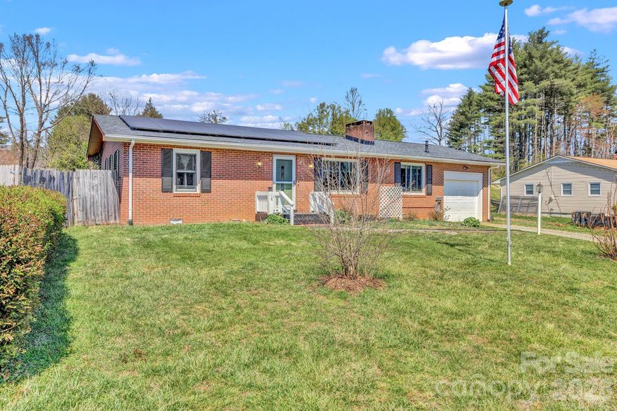 Welcome to 1195 Hendersonville Highway in Pisgah Forest, a well-maintained brick ranch in a highly convenient location just minutes from Pisgah National Forest and a short drive to both Brevard and Hendersonville.

Inside, the home features wood floors, built-in shelving, and a comfortable living room with a fireplace equipped with natural gas logs. The kitchen includes a breakfast area and connects easily to the main living space, making it functional for everyday living. The bathroom has been updated and includes a step-in tub for added accessibility. There is also a flexible additional room that can be used for guests, an office, or other needs. 

Recent updates include a roof replaced approximately two years ago, two front windows replaced around six years ago, and a solar panel system to help offset energy costs. Additional features include a gas (on-demand) water heater, an alarm system that conveys, a stainless refrigerator (approximately 2 years old) in the kitchen, and a second refrigerator in the mudroom.

Outside, the fenced backyard offers a great mix of usable space and functionality, complete with fruit trees and a greenhouse—ideal for gardening or hobby use. Distant mountain views add to the setting, giving you a sense of place without sacrificing convenience. Overall, this home offers a solid combination of updates, usability, and location.