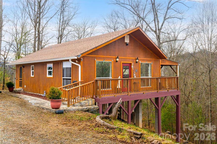 Three separate buildings on five private ridgeline acres with 360-degree views, just minutes from Asheville and Hot Springs. Panoramic mountain views and a ridgetop setting define this rare turnkey property offering exceptional privacy, usable acreage, and an established footprint ready for immediate enjoyment and long-term flexibility. The property includes a one-bedroom, one-bath primary residence plus a detached approximately 1,000-square-foot accessory structure suitable today as a workshop or studio, with strong potential for future conversion to second living quarters, guest space, rental use or creative workspace. An additional building site provides even more opportunity for expansion. This is not just a single small home, it’s a multi-structure mountain compound with room to grow. Being offered mostly furnished, including the TV and surround sound stereo system, the property is ready to enjoy from day one, whether as a full-time residence, mountain getaway or investment opportunity. On a protected ridgetop with expansive 360-degree winter views and immersive summer canopy views, the land is the defining feature. Surrounding peaks, adjoining private land, no visible neighbors, and no pass-through traffic create a remarkable sense of seclusion and tranquility. The setting delivers benefits of mountain living, such as clean air, protected natural surroundings, rich native soil and fresh water supported by an advanced filtration system with UV light treatment for added peace of mind. Existing improvements support immediate use while preserving flexibility for future vision. Naturally cradled by the mountains, the property feels secure yet remains well connected with high-speed internet available and convenient access to Hot Springs renowned mineral spas, Appalachian Trail, whitewater rafting, waterfalls, the French Broad River, Max Patch, and Asheville’s vibrant arts and music scene. Knoxville and Johnson City are also within comfortable driving distance. Absolutely no drive-bys. Private drive with limited turnaround at gate.