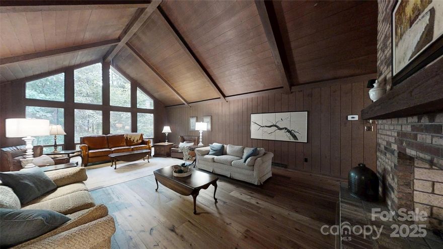 Walls of windows frame over 6 acres of privacy!  Vaulted wood ceilings are crafted with beams brought in from the mountains of NC in this custom built home.  A double sided fireplace anchors the space between the dining and living areas. On the main level there are 4 bedrooms, but downstairs offers so much more space with bonus rooms, a den with fireplace and a two car garage.  Don't miss the laundry shoot in the basement as well.  Unwind by watching the deer from the screened porch.  If you're looking for a serene escape to call home, this is it.