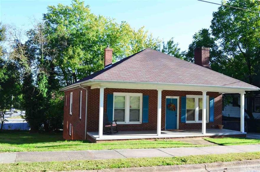 Move right into this all brick home with rocking chair front porch.  Hardwoods, laminate wood, and vinyl floors, neutral paint colors, replacement windows on heated living level.  Heating/ air installed 2009.  New tub surround in 2015. Electric stove, dishwasher, and microwave all remain. Central Newton location within walking distance to library, shopping, and restaurants.