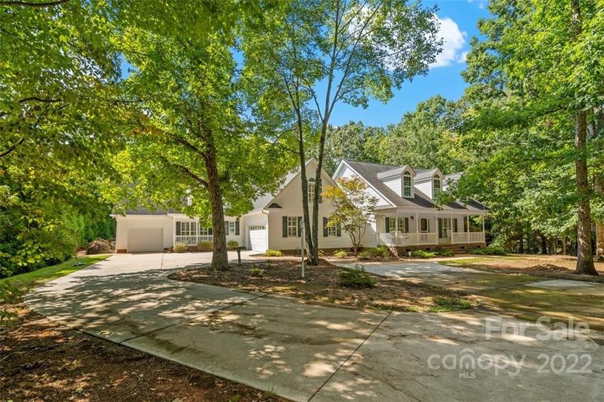 Rare opportunity! Gorgeous home with attached guest house set on 2 acres. The main house boasts three bedrooms downstairs and an additional bonus room with closet upstairs.  This home was custom-built with hardwood and tile flooring throughout and the bathrooms have been luxuriously fitted with tile surrounds.  The attached guest house features a private suite on the main floor as well as its own living room, kitchen, and laundry room. Upstairs in the guest house is a massive bonus area with walk-in attic access, a flex room that could function as additional sleeping space, and a sunroom.  Outside is a lovely stone gazebo that could easily be converted into an outdoor kitchen.