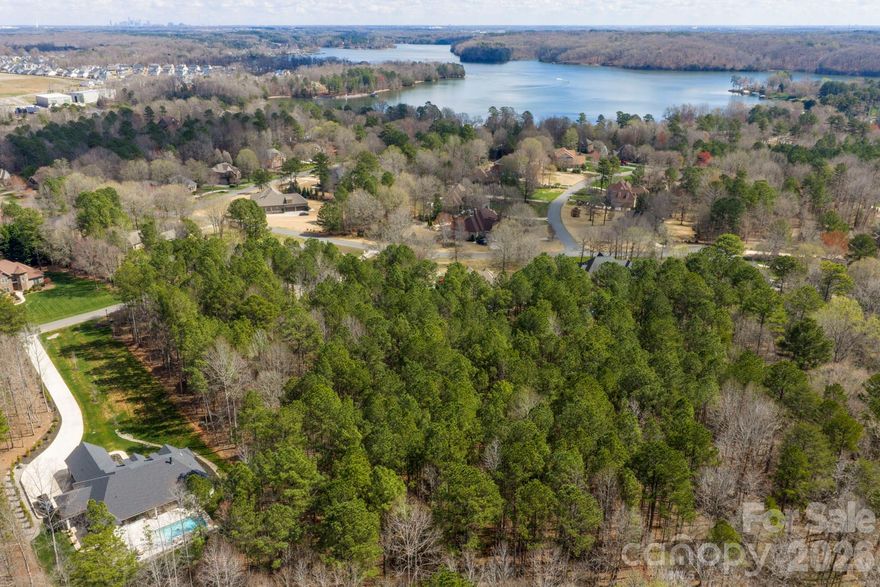 Rare build-to-suit opportunity near Lake Wylie. This expansive, ultra-flat 2.27-acre lot (Roughness
Rating 1, minimal flood risk/unshaded Flood Zone X) is a premium, high-and-dry parcel in the
highly desirable Carolina Coves. Surrounded by established luxury estates, the site provides the
ideal topography and clearance for a sprawling, custom wide-footprint home.
Unbeatable location for the lake lifestyle: Community on-site boat and RV storage and only
3.6 miles to the boat launch.
Great schools: Zoned for top-rated Clover District 2 schools (Lake Wylie High 9/10), and a
quick 35-minute commute to Uptown Charlotte.
Community standards ensure premium neighborhood valuation: requirements include full masonry
(front and sides), side-load or rear garages, and heavy-duty architectural shingles (2800 sqft min
for ranch / 3200 sqft min for two-story). Bring an HOA-approved builder to secure one of the few
remaining flat acreage lots in the area.