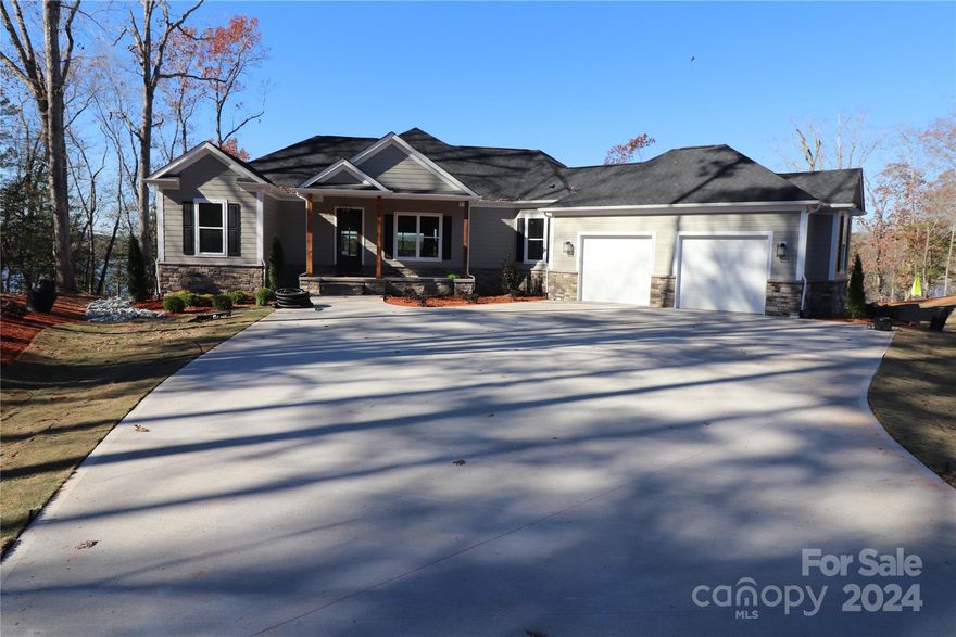 Beautiful main channel lake-front home on a large west-facing lot with 116 ft of waterfront in the highly desirable new gated Southpointe section in Tillery Tradition Country Club. 4 bedrooms/4 baths with lots of glass for those lake views from every level. Large rear upper porch plus an open deck and lower porch. Kitchen includes an island with breakfast bar, gas range, wall oven/wall microwave. Frigidaire Professional appliances. Walk-in pantry. Includes an elevator to make access even easier. Spacious main-level laundry. Lower level has a wet bar and connections for an extra refrigerator for party time. Generous space in the lower level living room makes a perfect spot for a pool table or other toys.  Tons of storage on the basement level with a double 8-foot door to store your golf cart, kayaks, and lake toys securely. A concrete golf cart path leads to a boat house and dock(by Mar 2024). Join Tillery Tradition Country Club and you have easy access to great golf, dining and a pool.