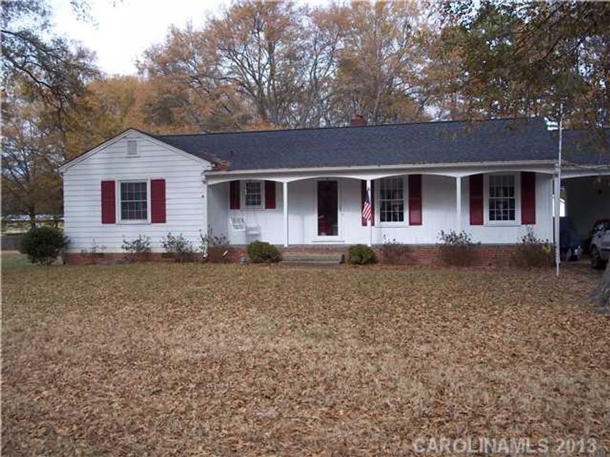 Large master suite hardwoods under carpet, all windows replaced, hardwoods 2 bedrooms, hall, living room & den, den FP w/gas logs, screened porch, long front porch, carport and utility room, detached garage 322 sq.ft., childs playhouse to stay, fenced yard.