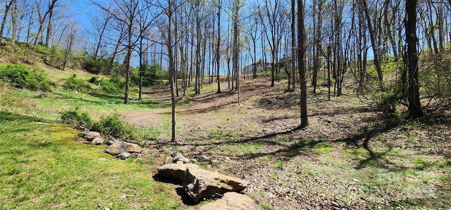 One of the best remaining lots in the coveted, award-winning community of Olivette! This gorgeous hillside homesite has a rare combination of features, including a corner location (multiple driveway options) and a gentle slope – enough for views, but without the high construction cost of steeper lots. Even better, the seller has readied the lot for immediate construction. Recently surveyed, soil tested, and cleared of undergrowth and brush. Unique neighborhood amenities include fiber-to-home internet, hiking trails, orchard, riverfront park, community gardens, and Olivette’s working organic farm. Walking distance to the French Broad River, Olivette’s waterfront park and pavilion, and the neighborhood’s private river island. The ideal canvas for an exceptional custom home!