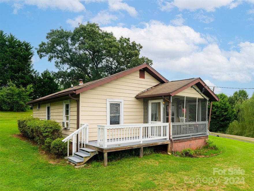 Welcome home to this sweet, well maintained bungalow on 0.84 acres with long range mountain views. Enjoy
the south/southwest facing views looking toward downtown Asheville and catch the occasional fireworks
displays over the city. This home was remodeled and updated by the previous owner in 2009/2010 and has
newer appliances. The roof and HVAC were replaced in 2011 approximately. The home's floorplan is laid out
nicely with a sizeable kitchen, separate dining area and living room that separates the two bedrooms.
There is a nice storage/tool and utility shed on the back edge of the property and a true rocking chair
screened in front porch! The yard is large enough to have a sizeable garden and chickens, if you like. The mature landscaping boast azaleas, crape myrtles, maple trees and a lush lawn. Come and add your personal touches to make this home your own!