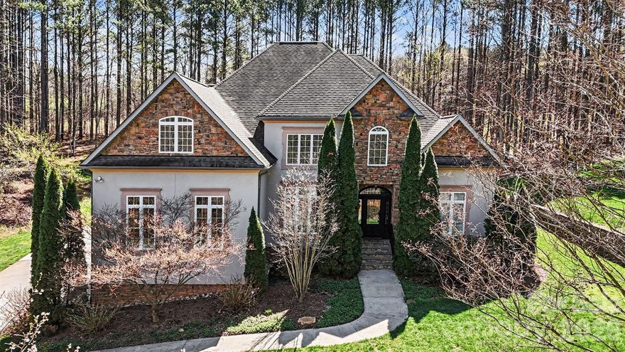 PRICE IMPROVEMENT OF $20,900! RARE OPPORTUNITY IN WINDING FOREST

Situated on 1.35 private, wooded acres in the highly coveted and sought-after Winding Forest subdivision, this elegant two-story estate home offers a blend of timeless design and functional living. Rare opportunities like this are hard to find, as each home in the community is uniquely crafted and set among rolling topography and mature trees. Community amenities include a pool, and the location provides convenient access to Lake Norman, with Skippers Landing Safe Harbor Marina just minutes away.

This home showcases custom finishes, soaring ceilings, and an abundance of natural light throughout. The main-level primary suite is a true highlight, featuring soaring ceilings and refined custom finishes. The primary bedroom, spa-like bath, and walk-in closet spaces offer a layout and design that must be experienced in person. The two-story great room with gas log fireplace provides an open and inviting living space. The kitchen includes stainless steel appliances, ample cabinetry, a center island, breakfast bar, and pantry, and flows into both formal dining and breakfast areas. Main-level laundry adds convenience.

Upstairs, two bedrooms share a Jack-and-Jill bath, while an additional bedroom includes a private ensuite. A spacious flex room and additional storage room provide versatility. The home also features a side-load three-car garage.

Enjoy outdoor living from the rear porch overlooking a private, tree-lined setting. This home showcases like a model  with features that are rare to find. Schedule your showing today - Preferred lender credits are also available!