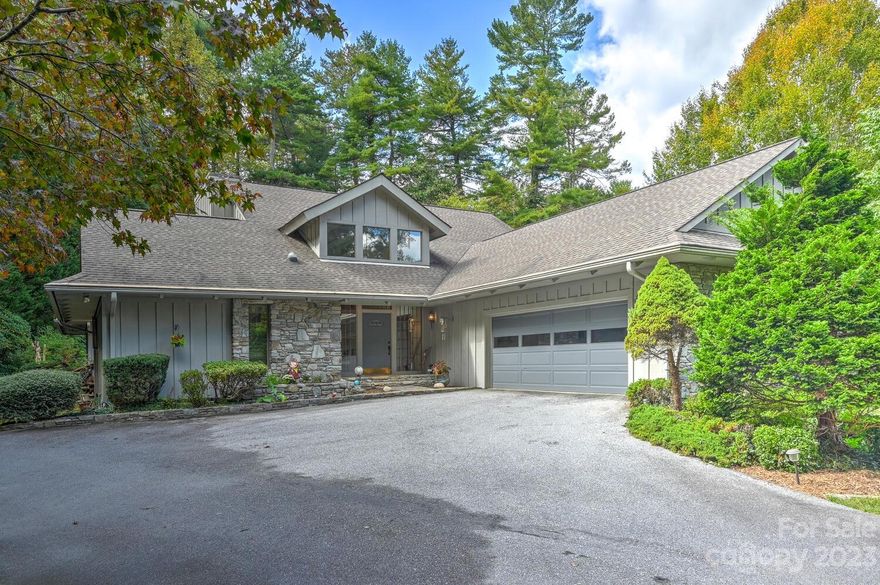 Experience the freedom to personalize your new home with the recent price improvement! Beautiful home on 1.38 acre with view of pond. This lovely home has it all, enter into the impressive foyer and see the massive staircase. Hardwood floors and solid wood doors and trim are a beautiful feature. There is an amazing kitchen with large island, custom hardwood cabinetry and dining area. Family room has a wet bar and vast fireplace with stone wall. This home boasts formal dining and living rooms, sun room, office, large laundry room and the perfect covered porch for your morning coffee.  The ELEVATOR takes you to the upper level to the primary bedroom and bath. Two separate attached garages. The exterior of the home has a large private yard, lovely landscaping and adjoins the community pond which is maintained by the HOA. Conveniently located off Little River Road, Carl Sandburg's and the Flat Rock Playhouse are right down the road.