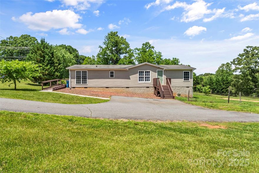 Welcome to 1730 Woodbend Ln in Conover, NC! This beautifully updated 3 bedroom, 2 bathroom doublewide offers 1,568 sqft of modern living on a spacious 0.34 acre lot. Enjoy the open concept layout, perfect for entertaining, featuring luxury vinyl plank flooring and an abundance of LED recessed lighting throughout the home. The custom kitchen boasts granite countertops, stainless steel appliances, and elegant cabinetry. Both bathrooms have been fully updated, including stylish tile showers. The split bedroom layout provides privacy, and the primary suite features a large walk-in closet. Step outside to a generous yard, ideal for many needs. The extended driveway offers ample parking space for multiple vehicles. This move in ready home combines comfort, style, and function in a peaceful setting. schedule your showing today!