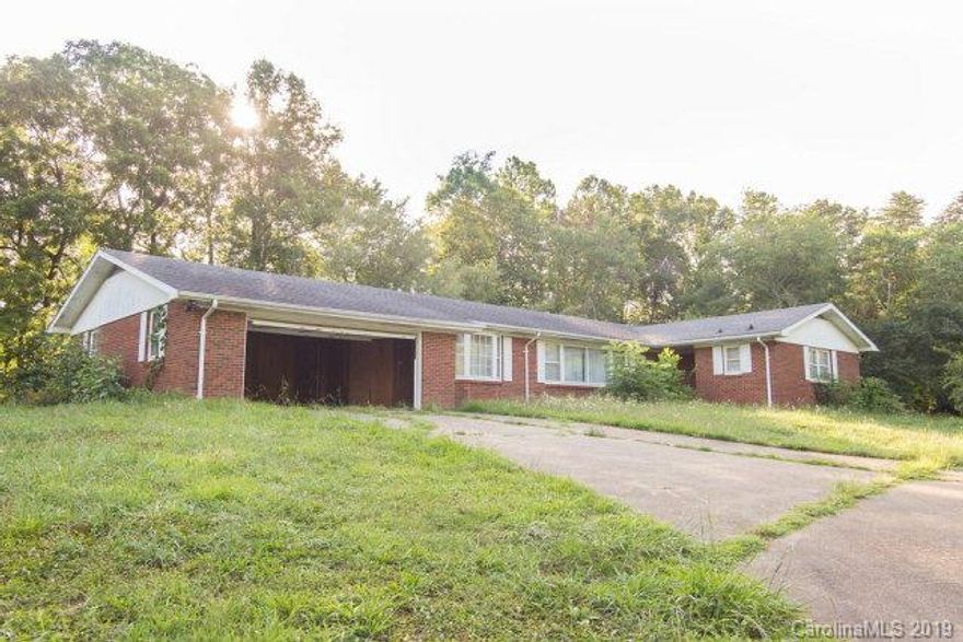 Sprawling Brick Ranch home on a beautiful piece of property located in the scenic Glenwood area.  Close to downtown & mere minutes from I 40 making it an easy commute to Asheville or Black Mountain.  This very large home features 4 nice sized bedrooms, 3 full bathrooms, a formal living room, dining room, den with circular brick fireplace, 2 car garage, and large eat-in kitchen.  Full unfinished basement with garage door offers another level of limitless potential (could be used for extra living space or workshop/office area and has another bath as well).  Situated on a grassed 5.51 +/- acres with mountain views.