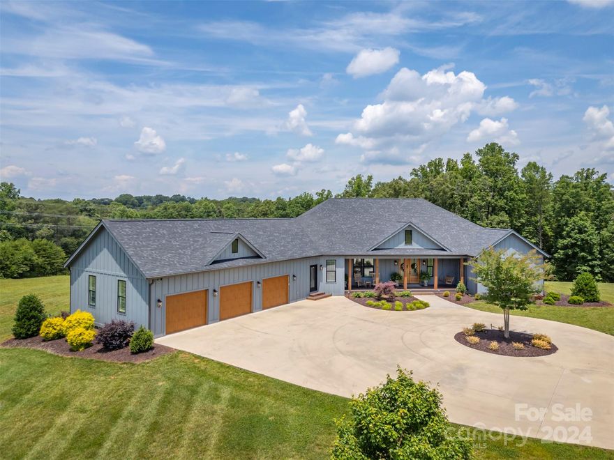 This beautiful custom-built home built in 2020 is a masterpiece of luxury. Sitting on private 8.05 acres, with no HOA or restrictions. The builder paid so much attention to detail. Norman plantation shutters throughout the home create a bright airy feeling. The open-concept great room includes vaulted ceilings and a cozy fireplace. The gourmet kitchen has custom cabinetry, a double oven, a gas range, and a large island. The gorgeous dining area is perfect for entertaining. The primary bedroom with beautiful trayed ceilings has an unbelievable walk-in closet and an ensuite with a large soaking tub, a shower, and a double vanity. There are also two bedrooms, a full bath, a half bath, and an office area on the main level. The lower level has a den/rec room, bonus room, full bath, kitchenette, garage/workshop, & multiple storage areas. The outdoor space is impressive with a covered porch, a screened porch, and a large porch across the front. Minutes from quaint downtown and 74/221 Highway.