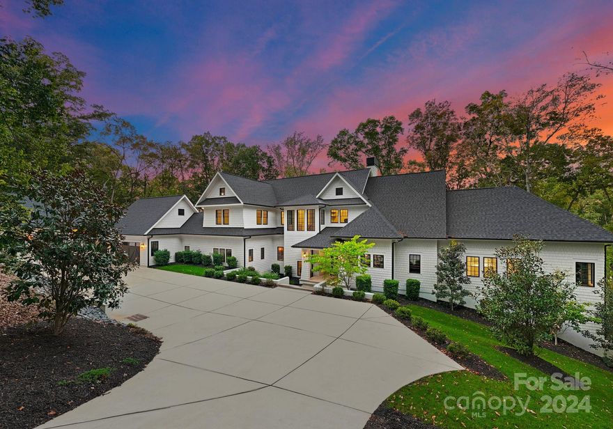 Private, gated modern estate on Lake Wylie situated on 3.9 acres. Meticulously designed home with luxury details throughout. Pivoting front door, open floor plan & water views from almost every room. Retractable doors in the great room & kitchen open to the lakeside screened balcony for entertaining. The gourmet kitchen is spectacular with the backlit cristillita quartzite countertops & entertaining bar.  The oversized primary suite features a fireplace & walkout balcony with retractable doors. The spa like bathroom has a soaking tub, double entry shower doors, backlit countertops, and recently installed custom closets and lighting.  Additional features include: Scullery,4 BR on the upper level with a recreational room,bonus room & 2nd laundry room: lower level has an oversized great room, bonus/flex rooms, home gym, theater room and a lakeside garage Outside features: pool off the kitchen, in-ground trampoline & multiple entertaining areas. Renderings available for a new private pier.