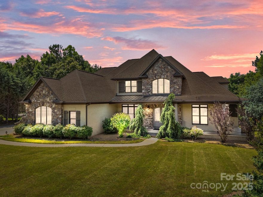 Experience space, serenity, and nature on nearly 2 acres with this custom full-brick home, ideally located near Birkdale Village, top-rated schools, and the heart of Huntersville. Thoughtfully designed with quality finishes, the main level features hardwood floors, vaulted ceilings, two fireplaces, a private office with coffered ceiling, and a luxurious primary suite with custom closet. The spacious layout includes dual staircases, three upstairs bedrooms, three full baths with tiled showers and granite counter tops, walk-in closets, and a large bonus room. Enjoy a pristine 3-car garage plus a separate garage with an extended driveway perfect for an RV, boat, gym, or guest suite. Plenty of outdoor living space including a wrap-around covered front porch and back deck with Trex decking, outdoor shades and covered veranda. Oversized chef's refrigerator, washer and dryer to convey!