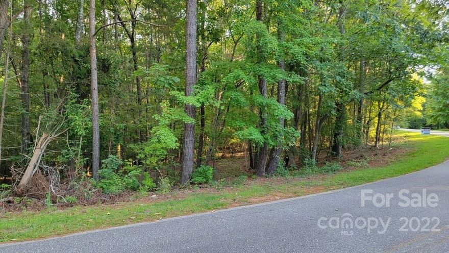 The opportunity to build your dream home on this well-sized lot is finally here! You are guaranteed privacy amongst the trees and can enjoy the quaint & quiet surroundings. The lot is sized to accommodate a 3 bedroom home, but can be upgraded to 4 bedrooms with the addition of 120 linear feet added to the drain field. Septic permit needed, but the permit to construct has been granted.