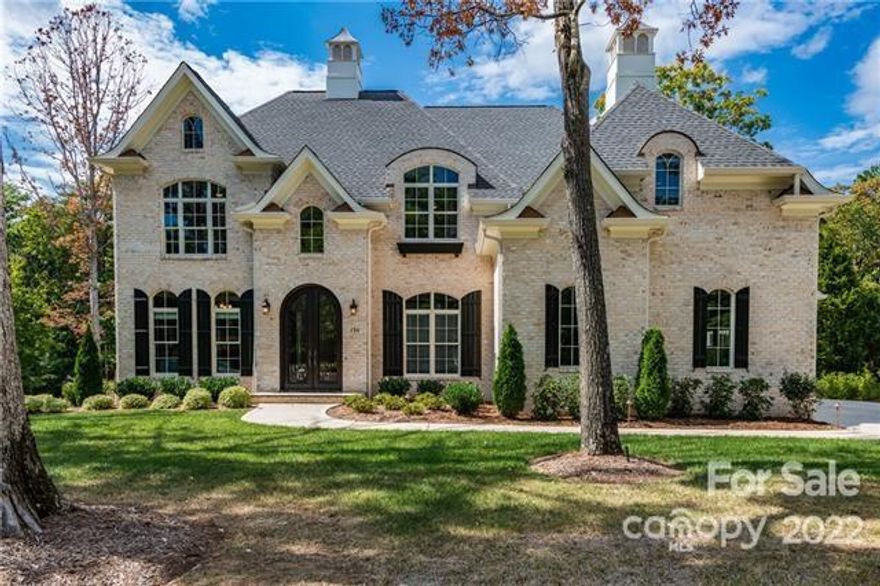 Location is Everything! Gated area in the Point CC with a deeded boat slip! Impressive open floor plan with spacious family room opening into the inviting large kitchen with custom quartz counters and plenty of seating and space for entertaining family and friends!
Elegant main floor Master Bedroom Suite spacious bathroom with custom finishes. Bonus main floor guest suite with private bath. 3Br upstairs with ensuite full bathrooms. Media room with bar area. Office/Exercise room with dual closets. Full laundry on the main floor with cabinets and storage. Outdoor covered porch with fireplace and Granite surround and grilling space. Beautiful spacious travertine patio for outdoor entertaining. Home has whole house water softener system. Deeded boat slip included for lake enjoyment!