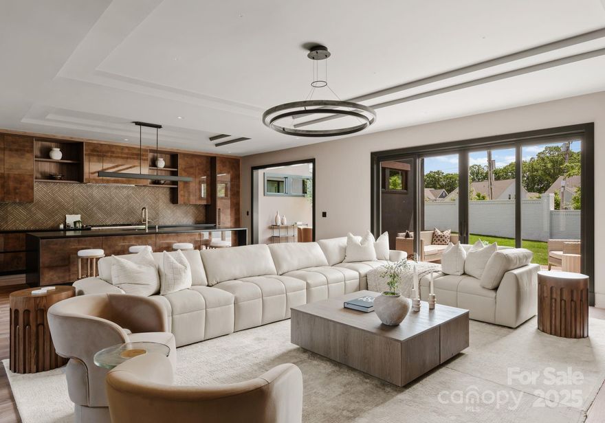 Discover the perfect blend of tranquility and modern sophistication in this newly built home by Sinacori Builders, inspired by the "Zen Modern" aesthetic. Designed to evoke calm with a contemporary edge, every detail reflects thoughtful luxury. Enter through a striking foyer adorned with a custom-designed raindrop chandelier, setting the tone for the elegance within. The dining room captivates with dramatic full-wall windows, white oak ceiling beams stain-matched to the cabinetry and floors, and a luxurious two-tier chandelier in handmade fluted glass. The kitchen and living spaces feature sleek Italian-imported cabinetry and built-ins in wood grain Cleaf and high-gloss Oro, offering both elegance and function. Spa-inspired primary bath complete with a steam shower system, crystal fireplace, and a free-standing soaking tub—your personal sanctuary. Illuminated throughout by curated designer lighting from Sean Levin, this home is a true masterpiece of comfort and style.