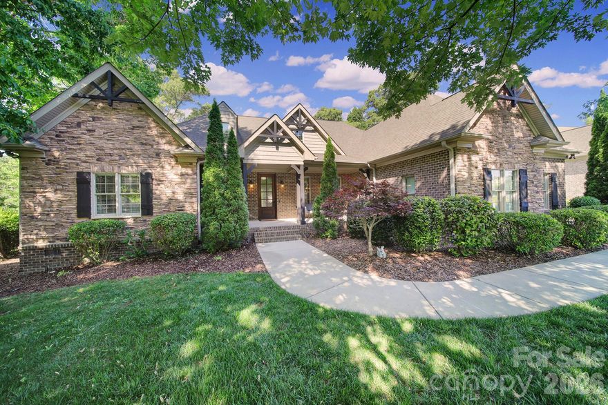 Step into a refined luxury lifestyle with this gorgeous custom Craftsman home, featuring full brick construction with stone accents and ideally located in the sought-after community of Stanton Heights. Built in 2014, this home offers the perfect blend of timeless craftsmanship and modern comfort.

A welcoming front porch sets the tone, while just off the foyer, a beautifully appointed formal dining room provides the perfect setting for elegant entertaining. The great room features custom coffered ceilings and a stunning stone fireplace, creating a warm and inviting atmosphere.

The designer kitchen is open to the great room and is thoughtfully equipped with stainless steel appliances, a gas cooktop, double ovens, a large island, and granite countertops—perfect for everyday living and hosting gatherings.

The luxurious primary suite is conveniently located on the main level and features a spa-like bathroom with granite finishes, heated floors, a spacious walk-in closet, a wet bar, and private access to the covered rear porch. Two additional bedrooms are also located on the main level, offering flexibility and convenience.

Enjoy exceptional outdoor living on nearly half an acre, complete with a resort-style, private wooded backyard featuring a custom pool, a large covered porch, and a hot tub that will convey. The securely fenced side yard offers the perfect space for a garden, play area, or pets, adding both functionality and charm.

Upstairs, you’ll find two additional bedrooms and a full bath, offering flexible living space ideal for guests, work, or recreation, along with generous walk-in storage.

Additional highlights include a tankless water heater, thoughtful upgrades throughout, and a three-car garage completing the home’s impressive features.

Ideally located just minutes from I-77, I-485, and Ballantyne, with access to award-winning Fort Mill schools. Enjoy the convenience of nearby amenities, including the ability to bike to the community pool and Greenway.

Experience the perfect blend of luxury, comfort, and functionality in this exceptional home.