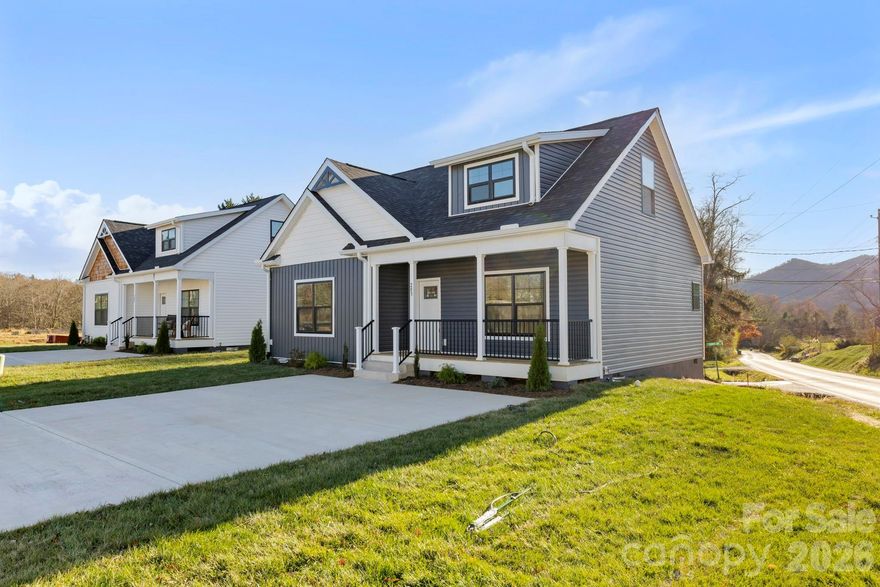 This charming new construction home is nestled in a small culdesac community minutes away from The Arboretum, Bent Creek & Biltmore Park amenities. The welcoming front porch and Craftsman details set the tone for the warm & cozy interior that awaits.  The light & bright open floorplan includes a spacious great room with 9' coffered ceilings and large windows. A sunny dining area opens onto a rear deck perfect for grilling. The kitchen offers a large island, pantry cabinets, tile backsplash and the ultimate spot to flex your green thumb. A generous primary bedroom on the main level leads into an ensuite bathroom w/ double vanities, LED mirrors, and an epic tiled shower w/ 2 heads and flip down seating.  The bathroom smartly connects to the main level laundry which also has a hallway entrance. A well placed powder room rounds out the first floor. Upstairs you will find an oversized landing perfect for an office area or flex space, 2 sizeable bedrooms w/ huge closets, and a full bath.  Outside, a small level yard provides an undemanding space to play or plant w/ mountain views beyond.  This home and community offer easy breezy living at an accessible price point, all within 20 minutes of downtown Asheville.