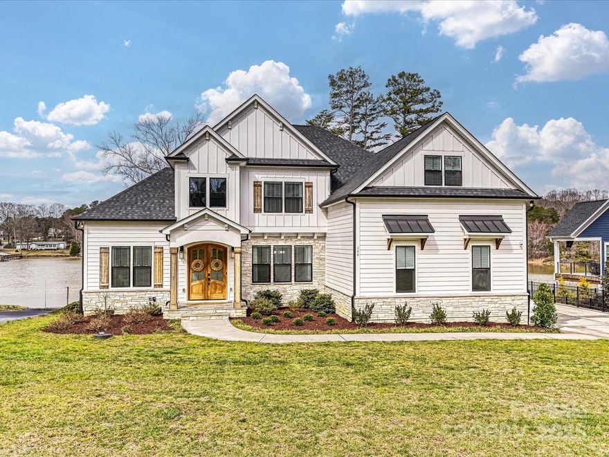 Wake up to breathtaking lake views in this luxurious waterfront retreat on Lake Norman. Tucked away in a quiet, private neighborhood, this home offers 100+ ft of pristine shoreline, year-round deep water, and a private dock—a true lake lover’s dream. The open-concept design is filled with natural light and high-end finishes, creating a seamless blend of elegance and comfort. The great room stuns with a coffered ceiling, cozy fireplace, and panoramic water views, while the chef’s kitchen boasts quartz countertops, premium appliances, and a walk-in pantry. The main-level primary suite is a serene escape with spa-like luxury. Upstairs, three spacious bedrooms, Jack & Jill baths, and a bonus room offer space for family and guests. Spend evenings unwinding on the vaulted screened porch or the open deck overlooking the lake. With a 3-car garage, ample storage, no HOA, and a prime location convenient to shopping, schools and I-77, this rare lakefront sanctuary is ready to be yours!