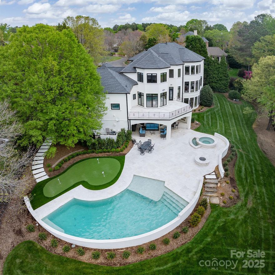 This is elegance at its best and nearly 100% NEW! With the golf course view, this home is ideal for both entertaining and quiet retreats. It offers stunning grounds with pool, spa, and firepit, all overlooking the 6th fairway. Two terraces span rear of home, complete w/outdoor grilling, leathered marble decking, and putting green! When you enter the new Clark Hall door, you’ll want to take in the views. Chef's kitchen, featuring quartzite countertops, comes equipped w/new Subzero/Wolf appliances, massive island, walk-in pantry, and a butler’s pantry. An elegant formal dining room and great room w/ modern fireplace complete the main living spaces. Main floor in-law suite includes a private library/office. The primary suite is located upstairs and features two custom walk-in closets, 2nd laundry room, and spa-like bath. The upper level also offers 3 ample-sized bedrooms w/baths. The basement has ultimate flexibility for recreation/entertaining, w/easy access to pool bath from exterior.