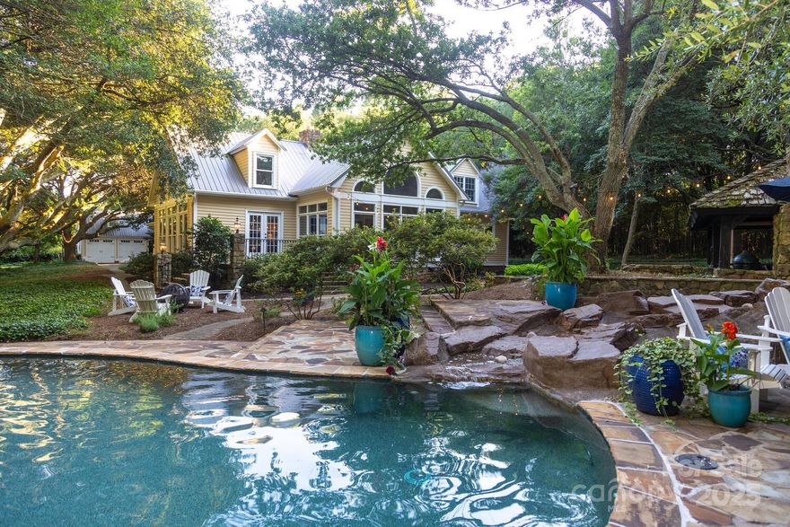 This Low-Country estate on 3.3 acres greets you w/a canopy of mature, live oaks lining your private drive! This exclusive, gated property offers a main house, plus a carriage house, providing multigenerational living and/or guest quarters. Main house features 4 bdr's, w/primary on main, 4.5 baths, hardwoods, gourmet kitchen, formal dining & breakfast, great room w/stacked stone fireplace & vaulted ceiling, plus sunroom & bonus. Carriage house offers 2 bdr's, 2 baths, 2nd full kitchen, living room, office, bonus, outdoor shower & a 3-car garage, septic permit unknown. Outside is a gorgeous pool, hot tub w/waterfall, flagstone pool deck w/covered pavilion perfect for entertaining. One deeded boat slip & boat lift included w/a jet ski pad on deep water w/main channel views. Community amenities include a large, covered dock, waterside fire pit, tennis/pickleball sport court, vegetable garden & koi pond. Convenient to Denver shops, a gym, eateries & breweries. Resort living at the lake!