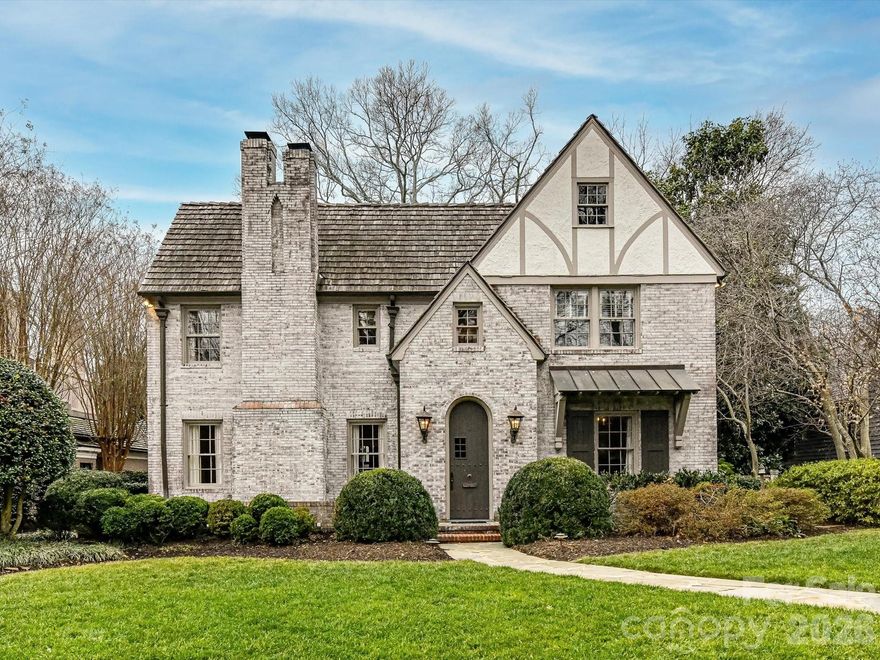 Located on the highly sought-after Queens Road West, this lovely Tudor home is beautifully updated for modern living while preserving all the best of days gone by.   The thoughtful layout makes for elegant entertaining, (the dining room!) while still finding the quiet moments.  Built-ins and bookshelves for the book lovers, create layers of design.   At the heart, is the gorgeous updated chef's kitchen with its oversized island meant for gathering, and a step away from the window-lined great-room with views to the lush private yard.  Upstairs, each of the 4 bedrooms has its own en-suite bath, deep closets and generous dimensions.  The upstairs laundry room & the downstairs mud rooms are loaded with storage, oversized sinks and room to maneuver.  And of course, the garage apartment -- complete with kitchenette & full bath, is the loveliest of guest retreats (or office or work-out studio?)   Serene and private, this beautiful 1936 home is a homage to lawn parties and cocktails by the fire, but easily manages homework at the kitchen table.  Come and see.
