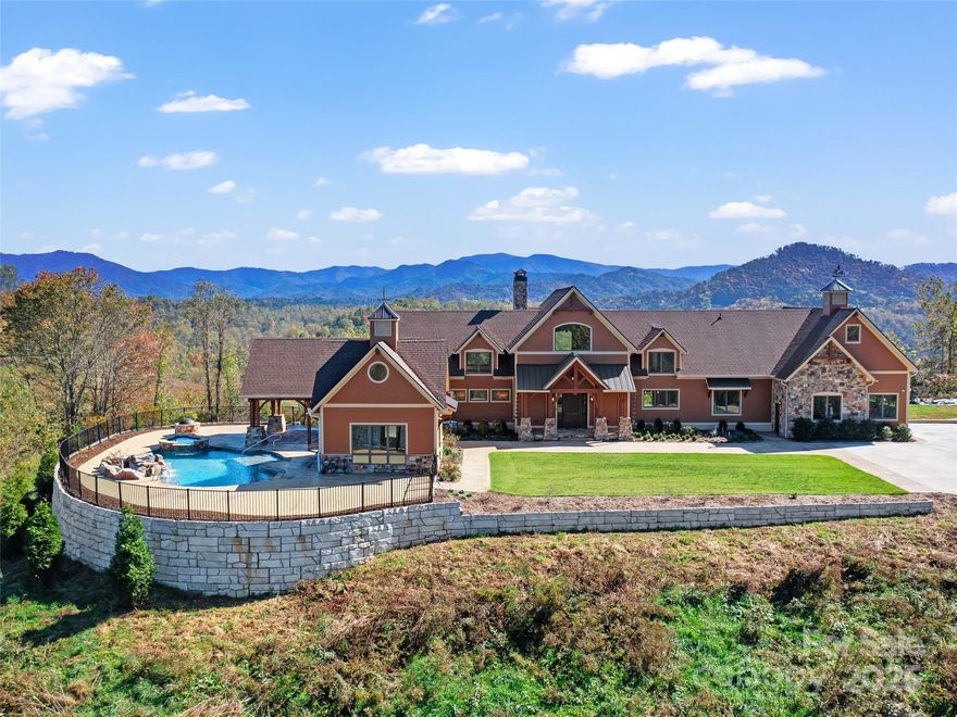 Spectacular Timberpeg Home, (the artisans of Post & Beam), situated on 51+ Acres in Western North Carolina with UNBELIEVABLE LONG RANGE VIEWS!  Built in 2020, as a forever home, this stunning Timberpeg home is located in one of Western North Carolina’s most breathtaking communities—just outside the quaint small town of Burnsville, home of Mt Mitchell, highest peak east of the Mississippi. This property offers unmatched peace, privacy, and panoramic VIEWS  that stretch for Miles & Miles—almost 360° views, with only some slight tree trimming. From the grand entrance with its impressive front door to the soaring Timber frame wood ceilings, this home is filled with warmth, charm, and timeless craftsmanship. Inside, you’ll find:An elevator for convenience to all floors.  A Beautiful Rock fireplace for cozy mountain evenings while you settle in for the night in the great room, watching your favorite football game!  A gourmet kitchen with a butler’s pantry and adjoining dining area, the perfect space for entertaining.  A flexible studio/library/office space you can create to meet your own needs could be used for so many possibilities.  A luxurious primary suite, also with a beautiful fireplace, has a spacious spa-like bath, heated floors, & heated towel racks with walk in closets.  En-suite bathrooms for every bedroom, all with heated bath floors.  Downstairs you will find such beautiful open space, a wet bar, and another fireplace for just hanging out. A wonderful Bed/Bath en-suite for complete privacy. A dedicated safe room/gun room with a full bath for your peace of mind if needed also downstairs.  Two rooms downstairs could also be finished out for extra square footage if needed.  Upstairs, 2 extra bonus rooms, waiting to be called yours!  Along with two beds, and two full baths en-suites.  We saved the best for last,  Step outside and enjoy your own mountain oasis, complete with a stunning heated saltwater pool with rock waterfalls, and a gas fire pit for ultimate entertaining.  A designated space is ready and waiting for your outdoor kitchen.  A whole-home generator also for peace of mind has been installed.  Beautifully designed concrete driveway with decorative stamped concrete borders, along with beautiful landscape await your arrival. Expansive decks to enjoy the beautiful mountain weather & the incredible views.  If you are looking for that special feeling when you walk inside your forever home, this is it!   Its all in the feeling!  Come breathe in the incredible mountain air and get a taste of what all we have to offer! (Septic permit is for 4 bedrooms), but there are actually 5 bedrooms, with possibility of adding more inside existing footprint.
Too many premium features to list—please see the feature sheet and videos for a full tour of everything this extraordinary home has to offer. also see 
virtual tour at  https://www.zillow.com/view-imx/c7df059a-c4c3-48f7-a44c-320aeee2c35a?setAttribution=mls&wl=true&initialViewType=pano&utm_source=dashboard
SEE YOUTUBE VIDEO ALSO.  https://www.youtube.com/watch?v=pqmf8W8-ji8&feature=youtu.be