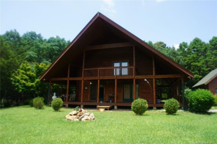 Southland Log home on quiet, serene setting of 18 acres. Wrap porch allows views of fenced pasture and stocked pond with pier. Great room rock fireplace, master on main with walk in closet, 2 BR, bath & bonus area upstairs. Exterior offers 24x28 garage with unfinished bonus overhead, 30x25 metal barn, 4 stall hay barn, tractor shed, chicken coup, fishing cabin and more!
